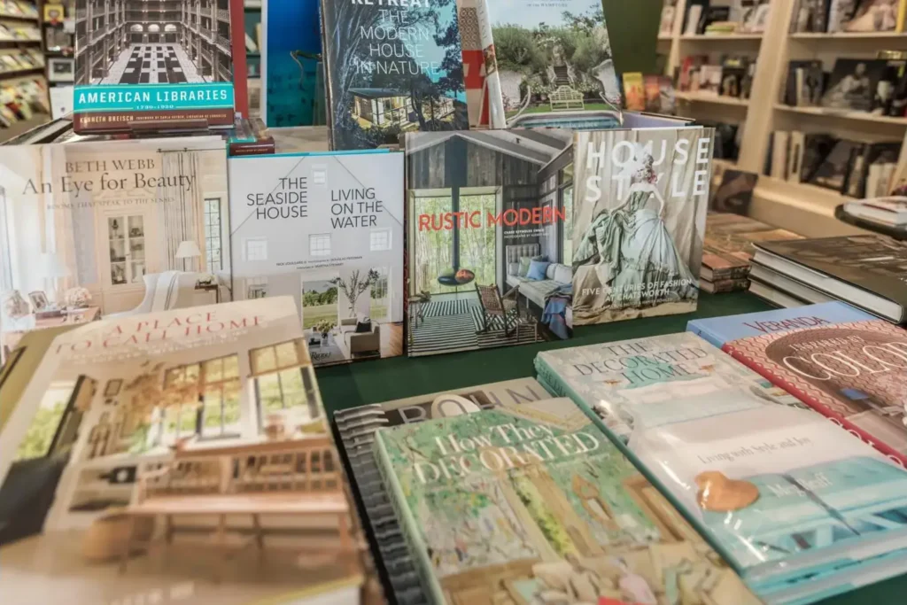 Book display in a library or bookstore, featuring a variety of home decor and architecture books on a green tablecloth.